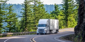 Commercial transport truck driving on a highway.